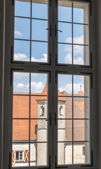 Ancient glass window with panoramic views over medieval buildings