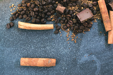 Sweet still life. Coffee beans, chocolate bars and cinnamon sticks.