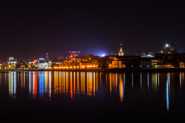 Fototapeta na wymiar Yekaterinburg, Russia - September,26,2016: Evening city lights and their reflection in water of pond.
