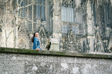 Fototapeta na wymiar Young Woman In Front Of Cologne's Cathedral