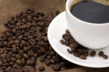 Coffee espresso and coffee cup and beans on table,Tea cup on table,warm cup of coffee on brown background,