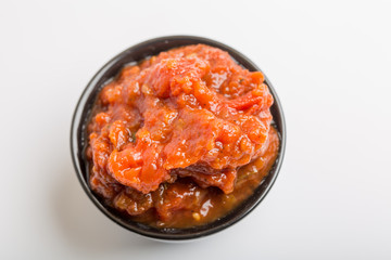 Close up of tomato sauce in a black cup
