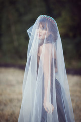 woman with a veil in the field
