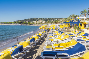 Rows of empty beach lounges in Juan les Pins, France - obrazy, fototapety, plakaty