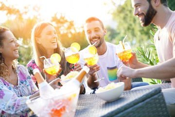 Group of friends cheering with summer cocktails