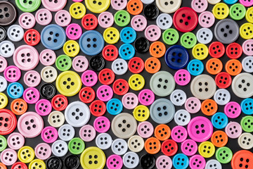 Fototapeta na wymiar Colorful plastic buttons arranged for background.