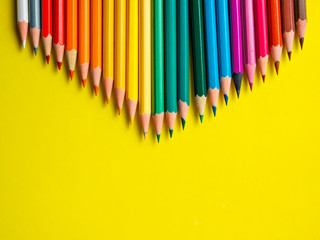 Colored pencil on yellow paper background for drawing color circle