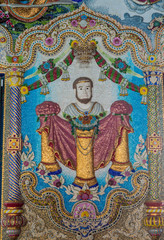 Obraz premium Traditional Thai style sculptures and painting in church under decoration of Wat Pariwas in Bangkok, Thailand.
