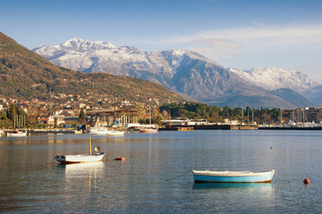 Fototapeta na wymiar View of the snow-covered mountain Lovcen from the Bay of Kotor. Tivat town, Montenegro