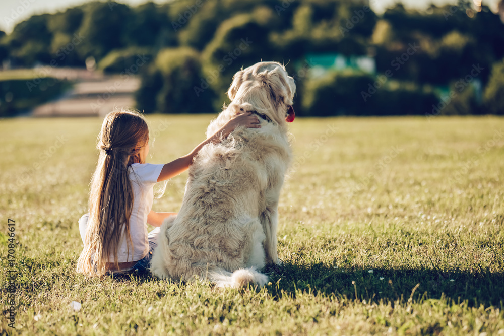 Wall mural little cute girl with dog