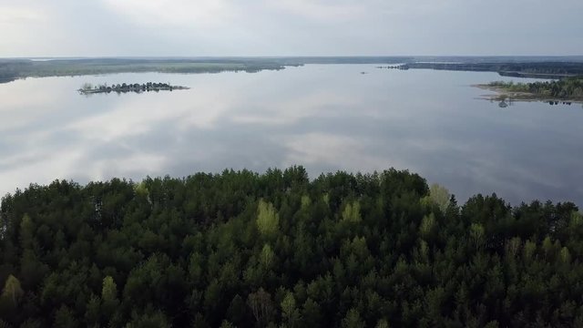 A large lake with small islands. Green Forest. T