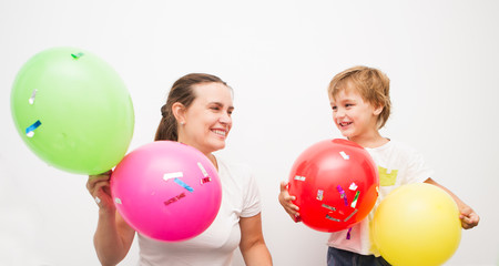 Fototapeta na wymiar Mother and mother and her little son are having fun with balloons.