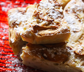 Homemade sweet apple pie with cinnamon and powdered sugar.