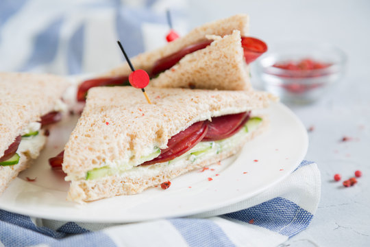 Club sandwich with meat, cucumber and cream cheese