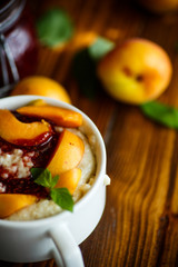 Oatmeal with jam and fresh apricots