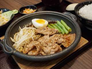 pork teppanyaki with egg and vegetables in hot plate Japanese Cooking