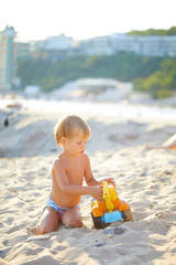 boy playing with toys on the shores of the black sea