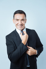 Cheerful pleasant man getting ready for work