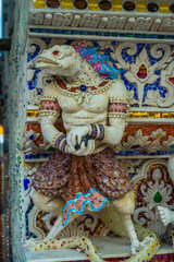 Fototapeta premium Traditional Thai style sculptures and painting of monster,animals and gods in church under decoration of Wat Pariwat