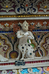 Fototapeta premium Traditional Thai style sculptures and painting of monster,animals and gods in church under decoration of Wat Pariwat