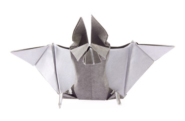 Gray bat of origami, isolated on white background. Stock photo.