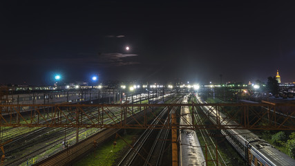 Fototapeta na wymiar night movement of trains on a railway junction in moon light