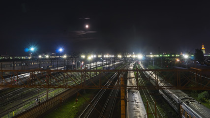 Fototapeta na wymiar night movement of trains on a railway junction in moon light