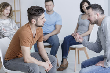 Psychologist talking to young man