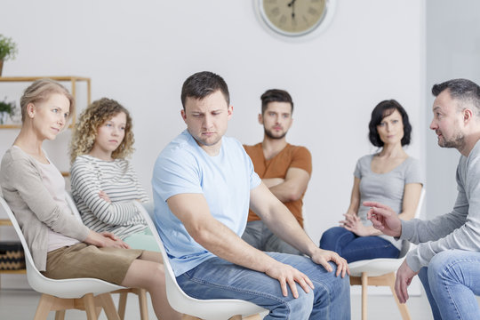 Unhappy man during group therapy