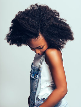 Shy Young African Girl Standing Sideways And Looking Down