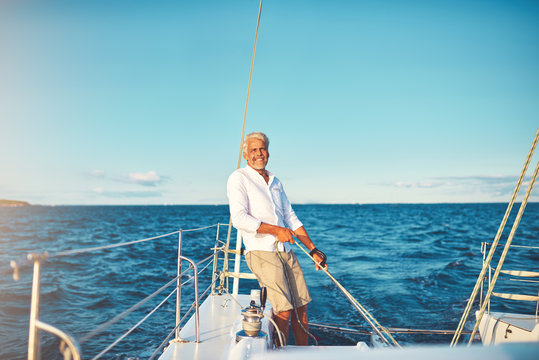 Smiling mature man out for a sail on his boat