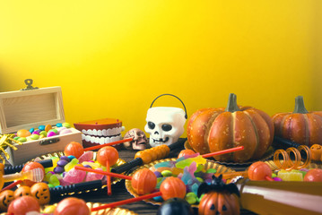colorful of candy dessert in halloween party with yellow ground