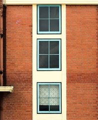 antique blue wood window at brown brick building