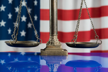 Law and justice symbols on American flag background.