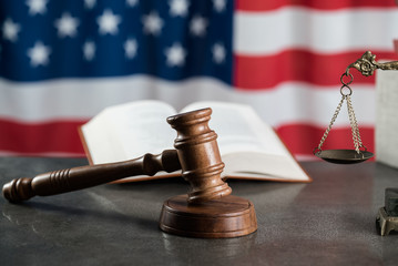 Law and justice symbols on American flag background.