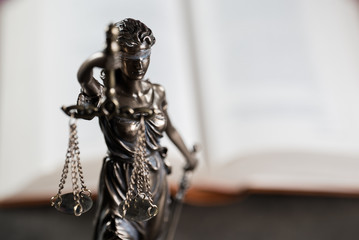 Law and justice symbols on American flag background.