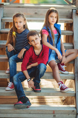 Three cute children are wearing autumn fashion clothes