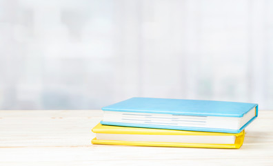 Colorful  notebooks on the tableon a wooden table.