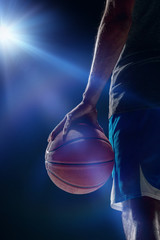 Fototapeta premium The portrait of a basketball player with ball