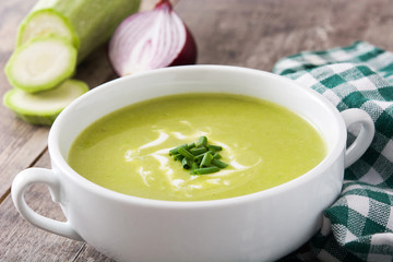 zucchini soup in bowl on wooden table