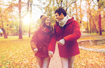 Fototapeta premium happy young couple walking in autumn park