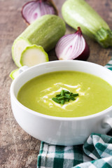 zucchini soup in bowl on wooden table