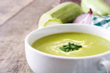 zucchini soup in bowl on wooden table