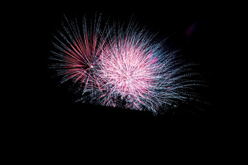 firework celebration, with a multiple long exposure to capture the movement of the explosion.black sky background