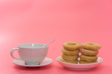 Fried Donuts with sugar topping on pink background