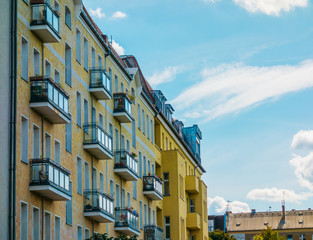 Fototapeta na wymiar yellow apartment buildings with small balcony