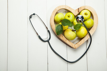 Health. Fresh apples on a white wooden background