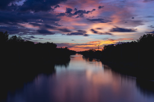 Colorful sunset sky over a countryside river