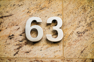 number 63 on marble background