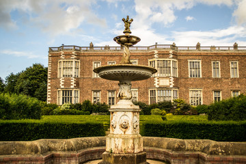 fountain in front of stately home 